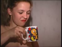 Cute babygirl in pigtails pisses in a mug and drinks her fresh piss